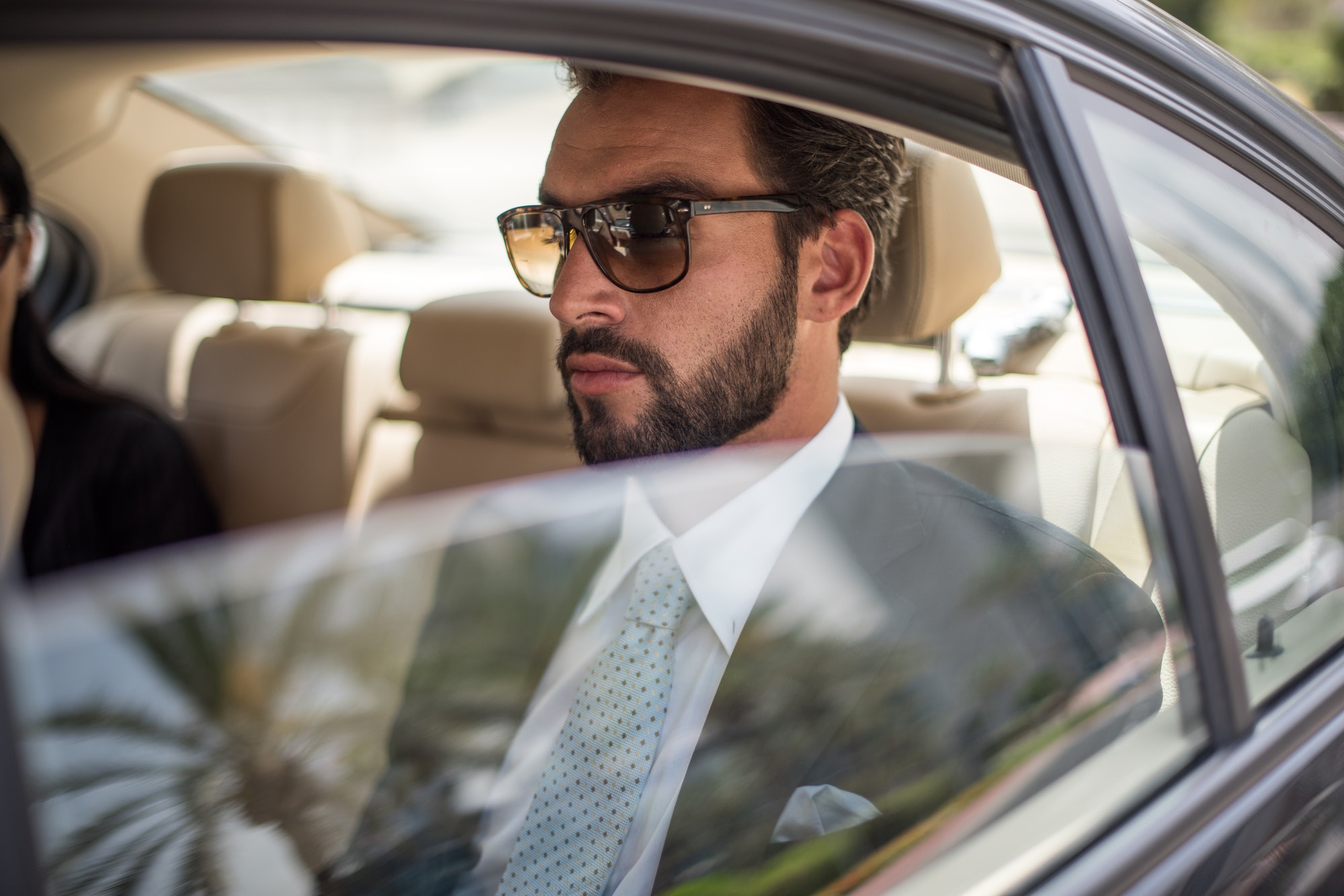 young-businessman-wearing-sunglasses-in-car-backseat-dubai-united-arab-emirates.jpg